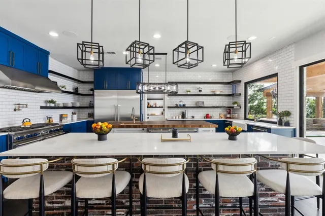 a kitchen with a table chairs and stove