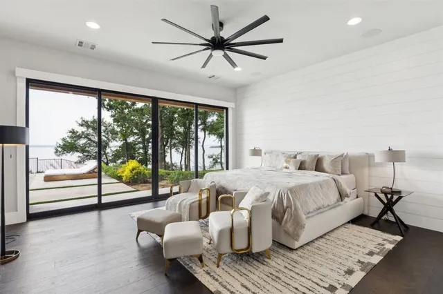 a spacious bedroom with a bed and a large window