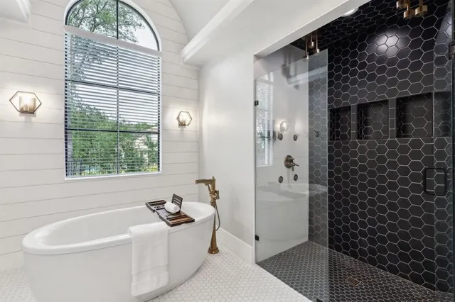 a bathroom with a bathtub and a shower