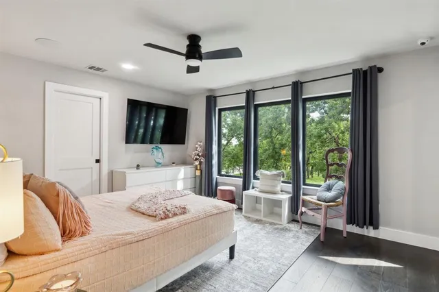 a bedroom with a bed and a large window