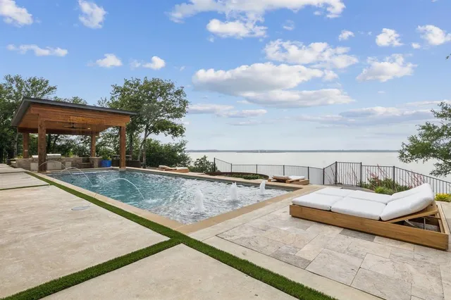 a view of swimming pool with a lounge chair