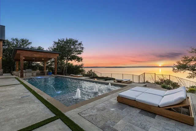 a view of a balcony with wooden floor and outdoor seating