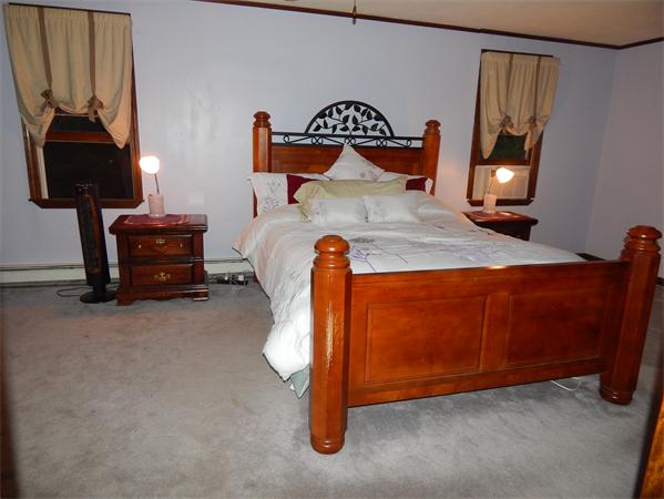37 Howland Road Lakeville, MA 02347 - Photo 11 of 14 a bedroom with a bed and a lamp on table