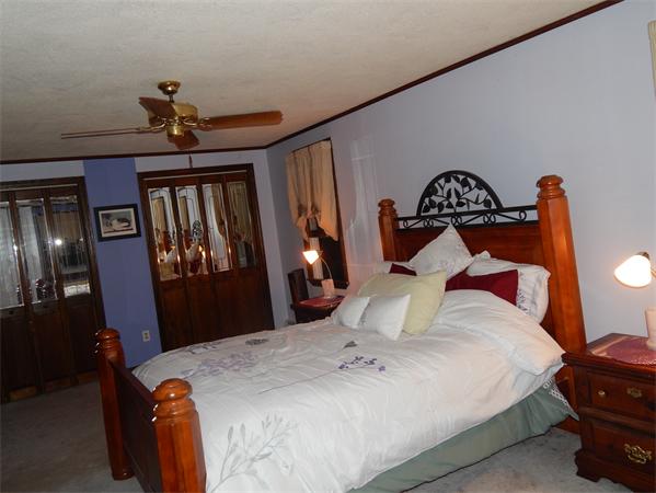 37 Howland Road Lakeville, MA 02347 - Photo 12 of 14 a bedroom with a bed and wooden floor