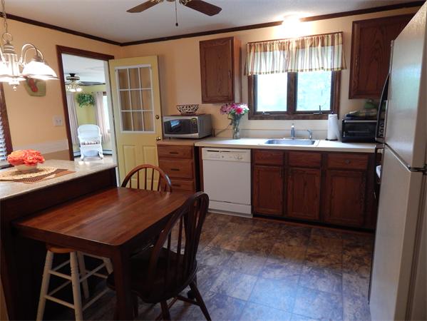 37 Howland Road Lakeville, MA 02347 - Photo 3 of 14 a kitchen with a table chairs stove and refrigerator