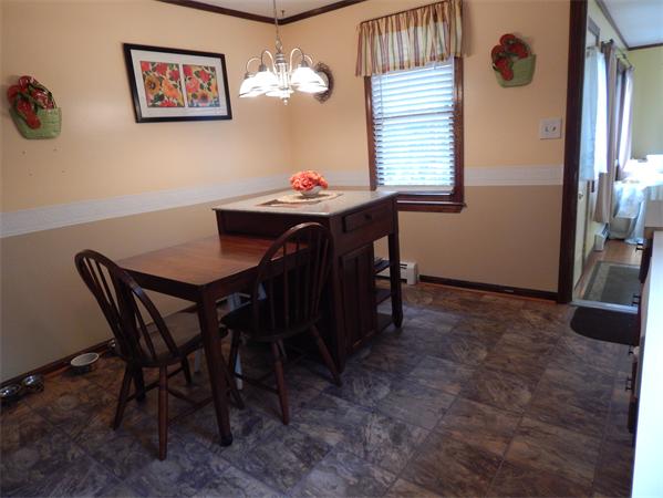 37 Howland Road Lakeville, MA 02347 - Photo 4 of 14 a view of a dining room with furniture and a chandelier