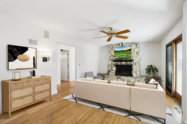 a bathroom with a granite countertop sink toilet and a mirror