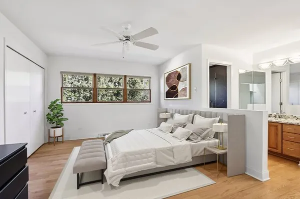 a view of a livingroom with wooden floor and a ceiling fan