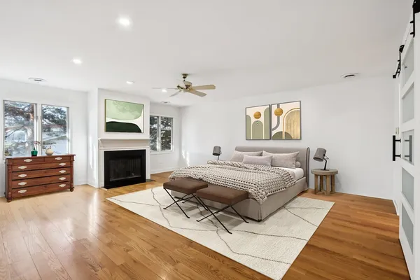 a view of empty room with wooden floor and ceiling fan
