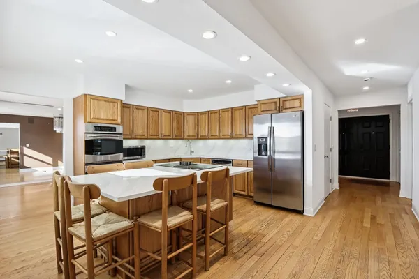 a kitchen with a stove a sink a microwave and cabinets