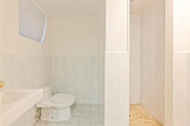 a bedroom with a bed couch and a dresser