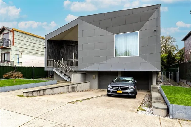 an aerial view of multiple houses with a yard