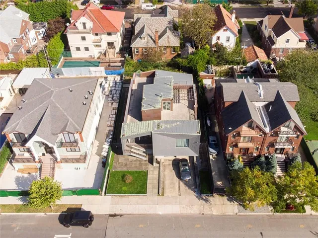 an aerial view of residential houses with outdoor space