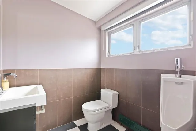 a large bathroom with a glass door shower and a sink