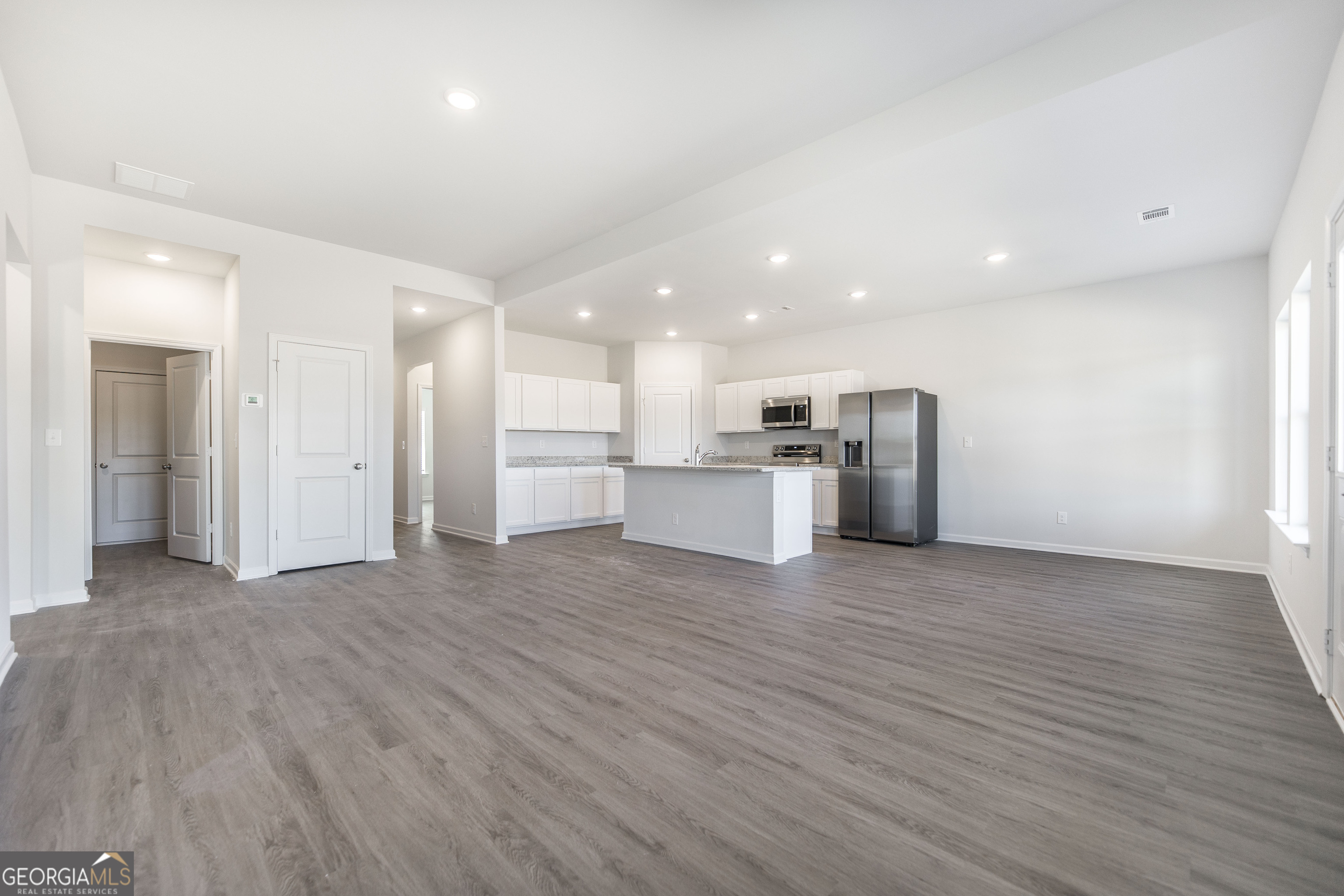 102 Monroe Court Byron, GA 31008 - Photo 5 of 30 a view of a electric appliances in kitchen and empty room with wooden floor