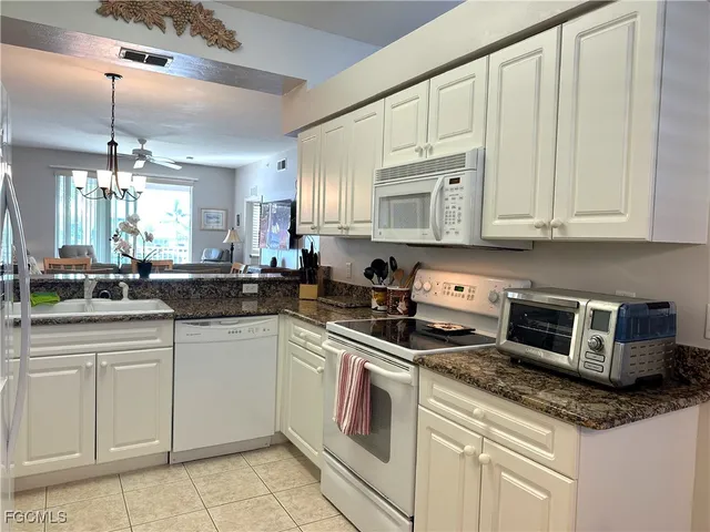 a kitchen with stainless steel appliances granite countertop a sink and a stove