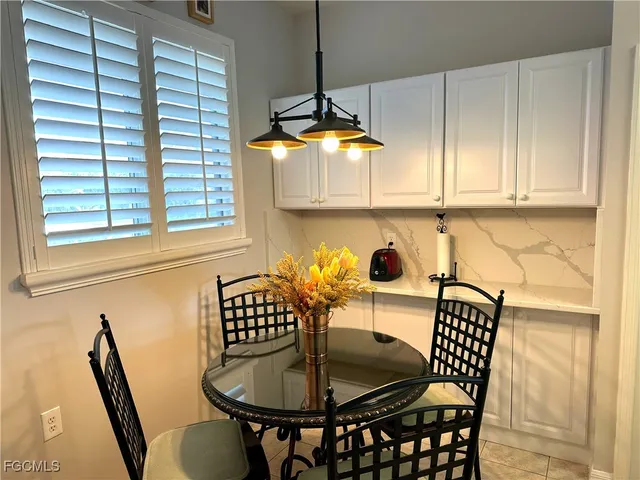 a dining room with furniture and window