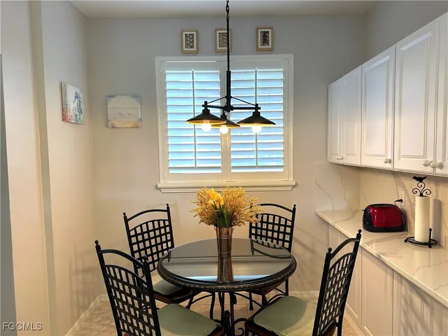 a dining room with furniture and window
