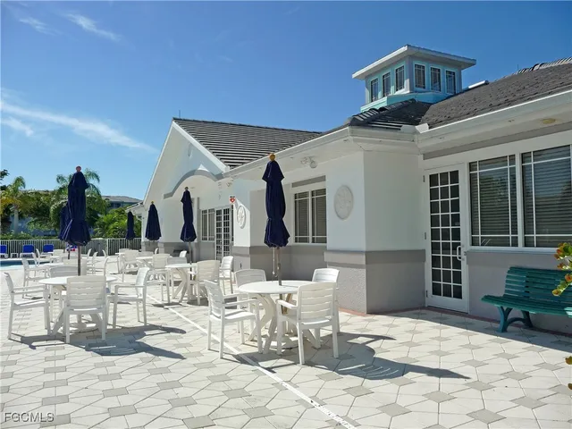 a view of a swimming pool with an outdoor space and seating area
