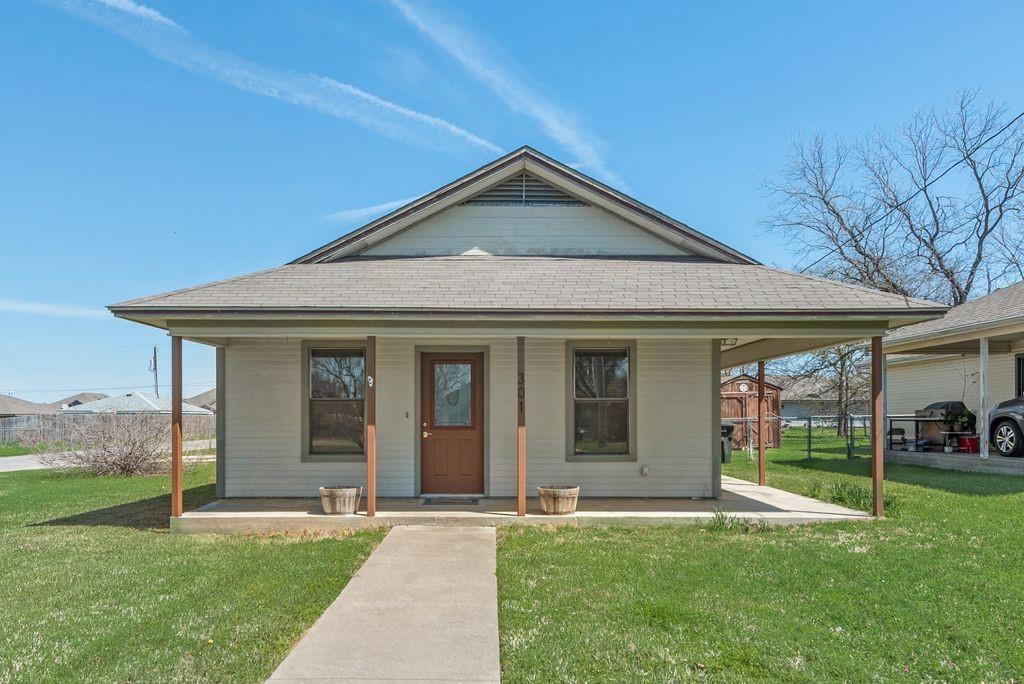 301 Lipscomb Street Cleburne, TX 76031 - Photo 1 of 21 a view of a house with garden and porch