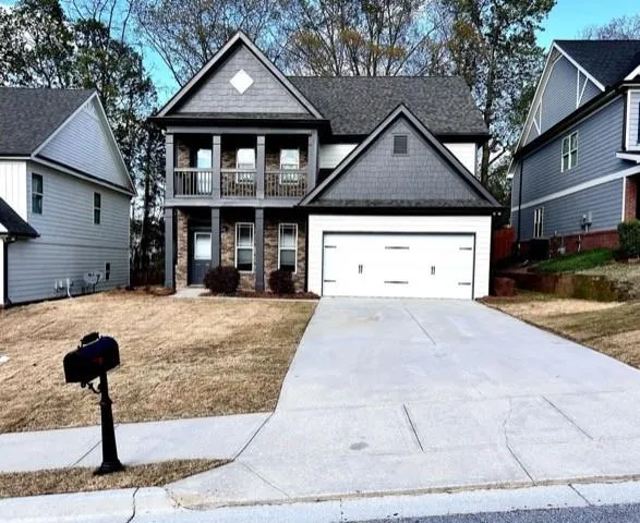 a front view of a house with a yard and garage