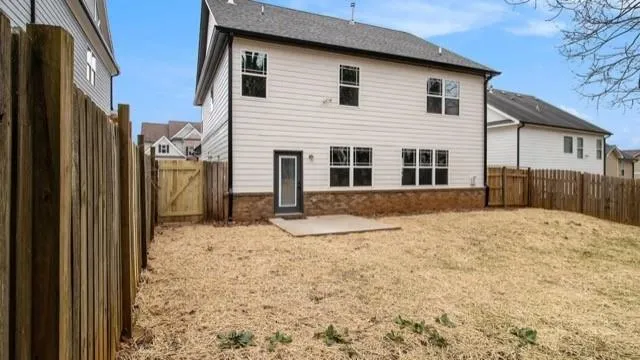 a view of a house with a wooden fence