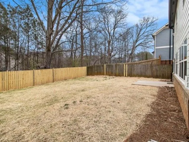 a swimming pool with trees in the background