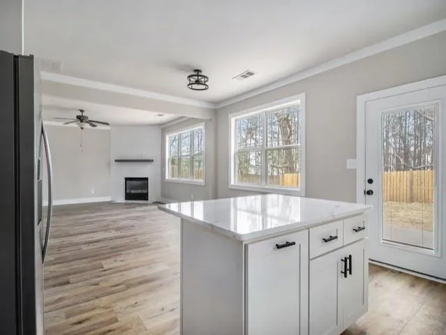a kitchen with granite countertop a sink stove and refrigerator
