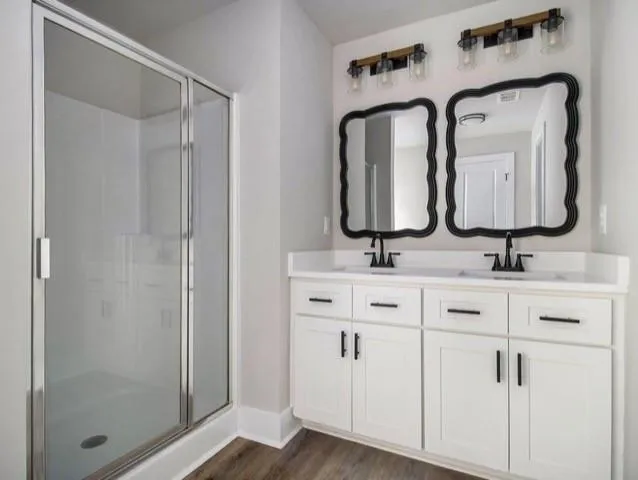 a bathroom with double vanity sinks and a mirror