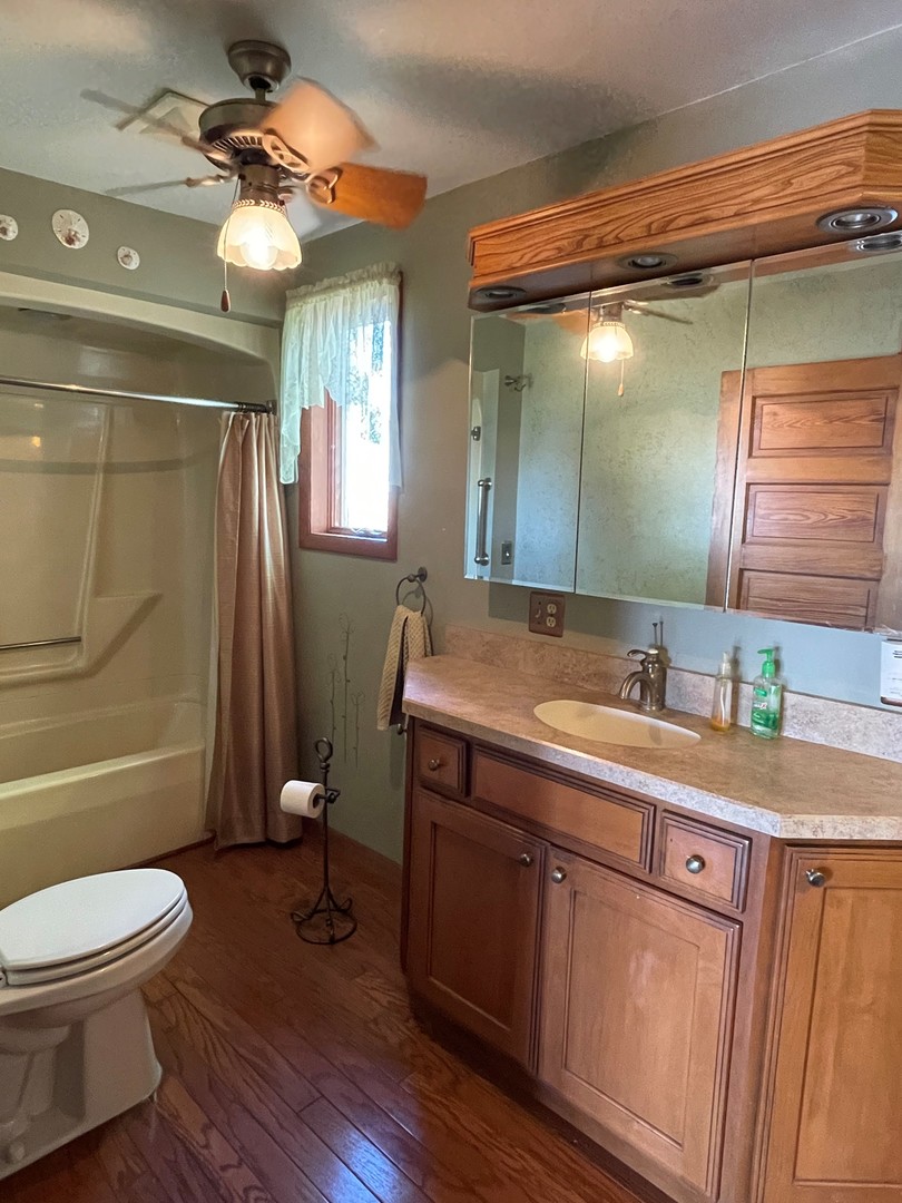 16580 West 5000S Road Buckingham, IL 60917 - Photo 20 of 35 a bathroom with a sink a toilet a mirror and shower