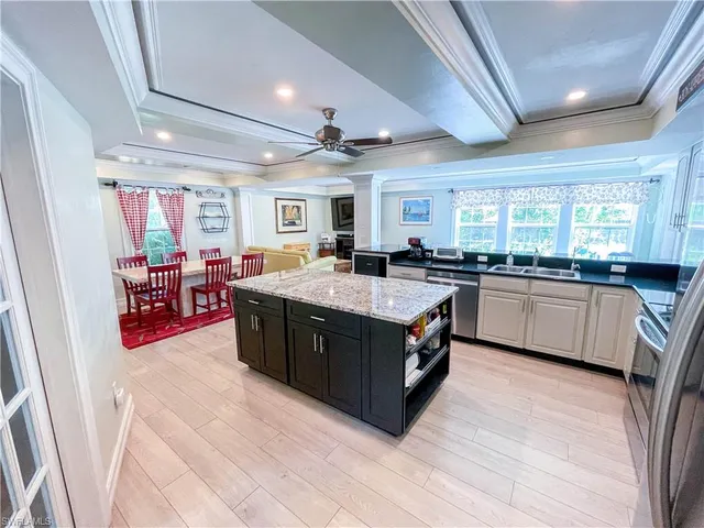 a kitchen with stainless steel appliances granite countertop a sink counter space cabinets and a large window