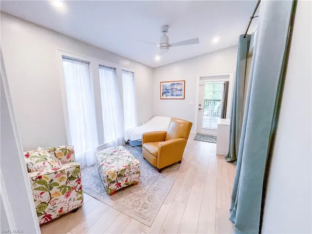 a bedroom with furniture and a wooden floor