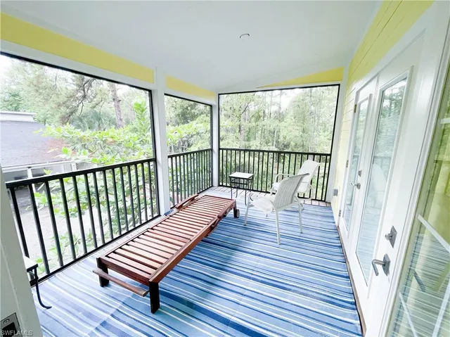 a view of balcony with wooden floor