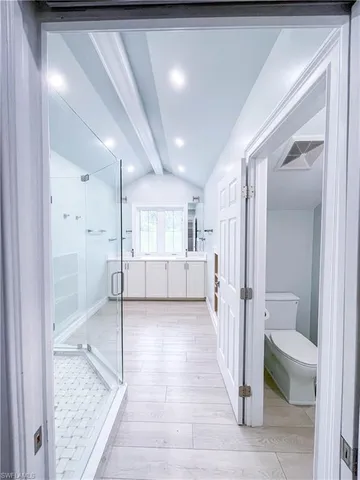 a bathroom with a shower and a sink