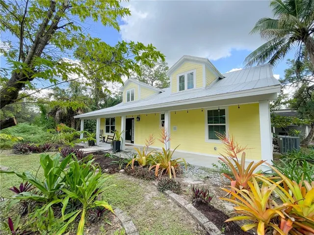 a front view of house with yard outdoor seating and barbeque oven