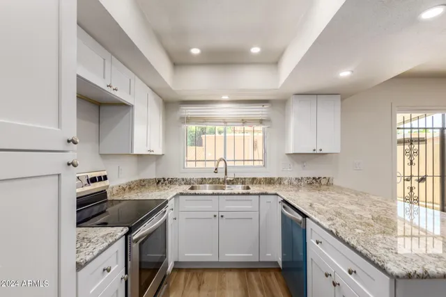 a kitchen that has a sink and a stove in it