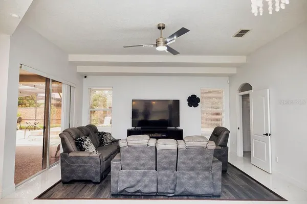a living room with baby crib furniture and a wooden floor