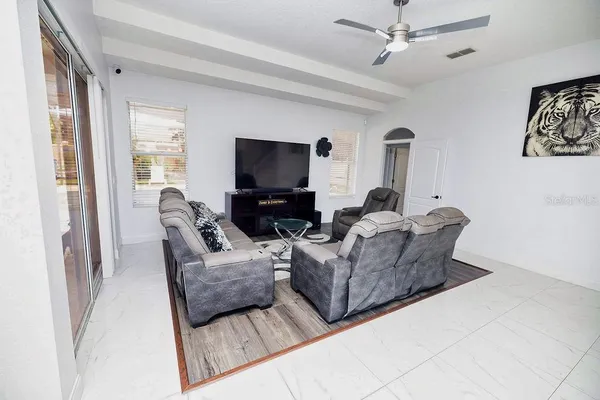 a kitchen with stainless steel appliances granite countertop a stove top oven a sink a dining table and chairs with wooden floor