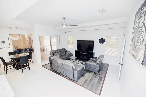 a large white kitchen with kitchen island a sink a stove and refrigerator