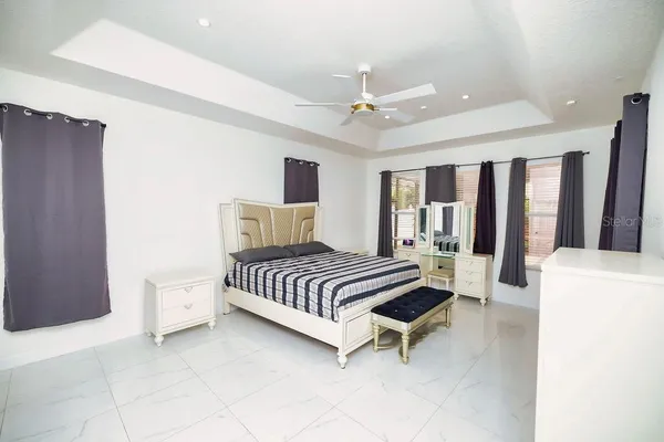 a living room with furniture and a floor to ceiling window