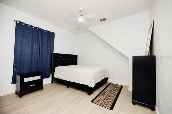 a front view of a house with garden and trees