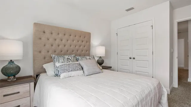 a bedroom with a bed and lamp