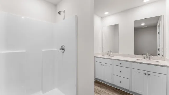 a bathroom with a double vanity sink and mirror