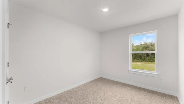 a view of an empty room with a window