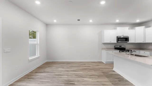 a view of a kitchen with electric appliances