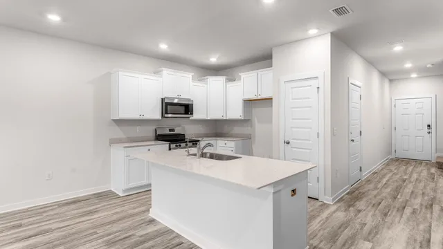 a kitchen with a sink a counter top space and cabinets