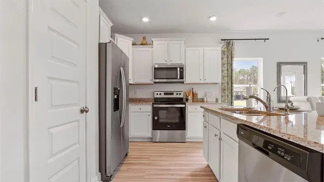 a kitchen with stainless steel appliances a refrigerator stove and sink