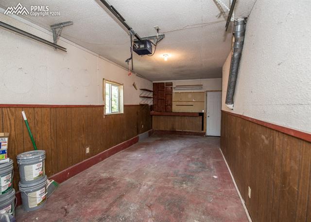 408 Placid Road Colorado Springs, CO 80910 - Photo 32 of 36 Inside the 1 car attached garage. It's extra long with a work bench area.