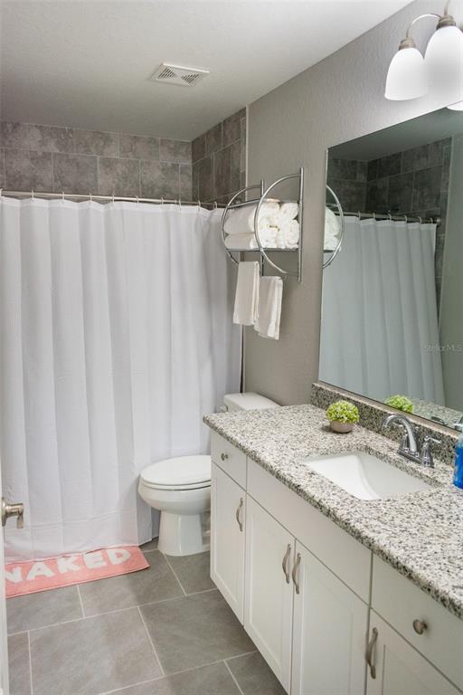 20109 Southwest 84th Street Dunnellon, FL 34431 - Photo 7 of 10 a bathroom with a granite countertop sink and a mirror