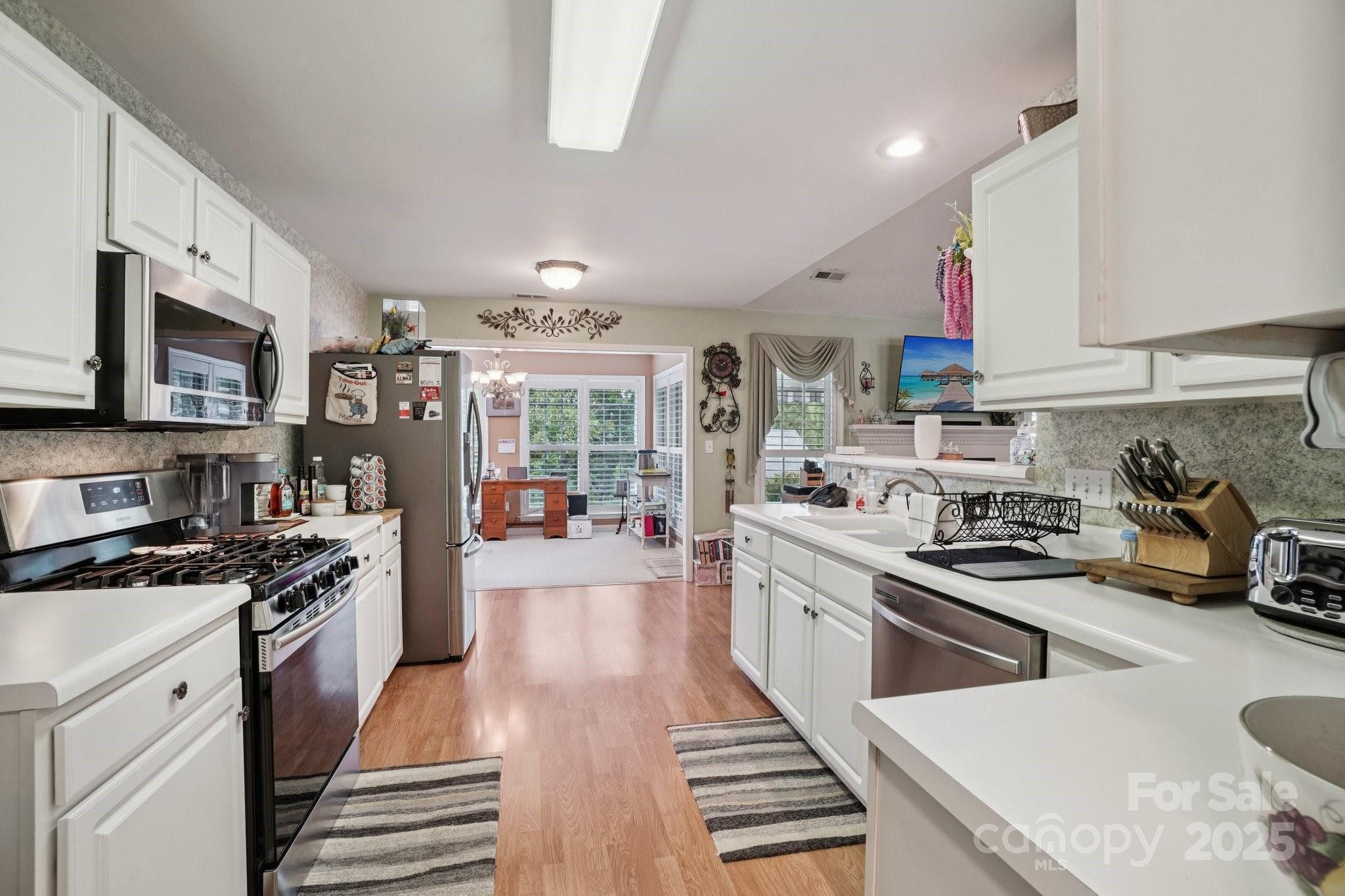 133 Stonehollow Road Fletcher, NC 28732 - Photo 11 of 29 a kitchen with stainless steel appliances granite countertop a stove a sink dishwasher and a microwave oven with cabinets